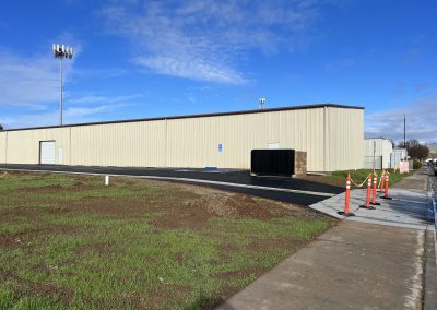 Completed commercial metal building with fresh asphalt — commercial construction Bakersfield CA