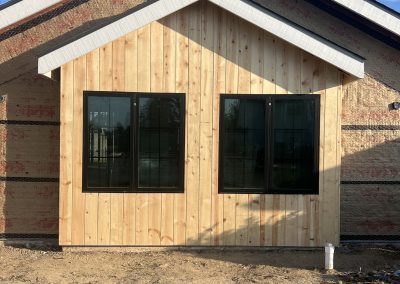 New ADU exterior with cedar siding and black frame windows — ADU construction Kern County