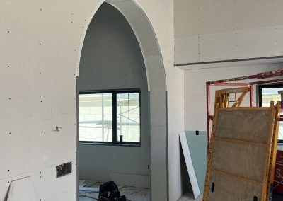 Arched window niche framing in progress — custom home remodel Kern County CA