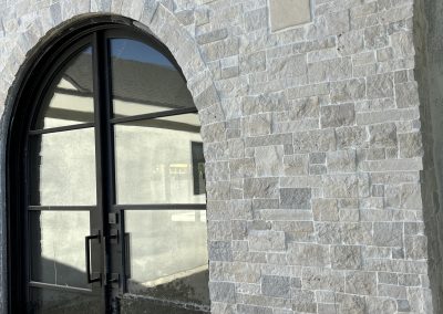 Custom stone facade closeup — residential exterior construction Kern County CA