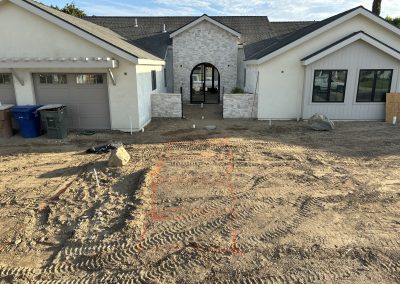 New home exterior under construction with arched entry — Bakersfield general contractor
