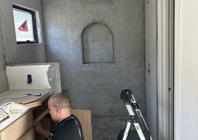 Concrete master bath shell under construction with crew — residential build Bakersfield