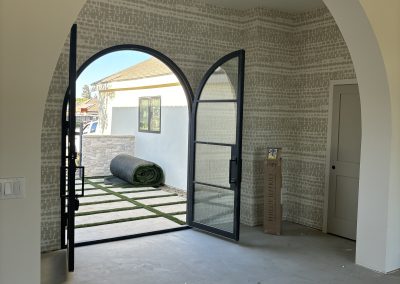 Custom arched iron gate doorway — luxury residential construction Bakersfield