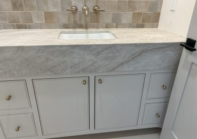 Gray double vanity with tile backsplash completed — bathroom remodel Kern County