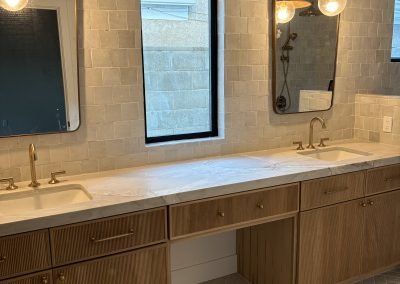 Bathroom with floor-to-ceiling tile and custom wood cabinets — Kern County home remodel