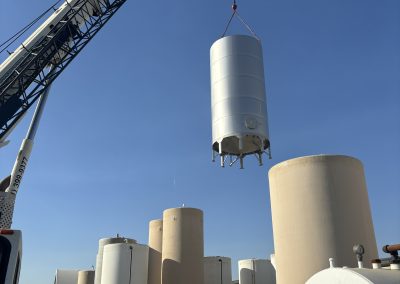 Crane lifting industrial storage tank — heavy industrial construction Central Valley