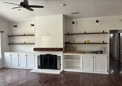 Shiplap fireplace feature wall with floating shelves and hardwood floors — home remodel Bakersfield CA