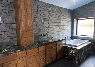 Bathroom with stone vanity and custom tile — residential remodel Bakersfield CA