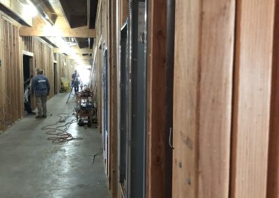 Commercial hallway framing in progress — interior construction Kern County